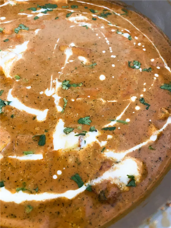 close up of an Indian curry with cream on top